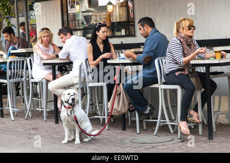 People sitting outside a cafe along Rothschild Boulevard in Tel Aviv, Israel Stock Photo