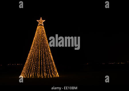 Star on top of an outdoor christmas tree, kent, uk Stock Photo - Alamy