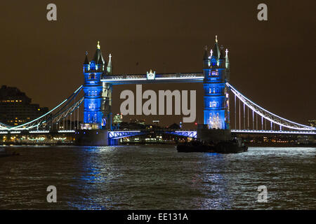 London, UK. 11th Jan 2015. Tower Bridge, seen here in blue, is illuminated in the colours of the French Tricolore flag, as a tribute to the victims of the terrorist attacks in Paris. Credit:  Jamie Hunt/Alamy Live News Stock Photo