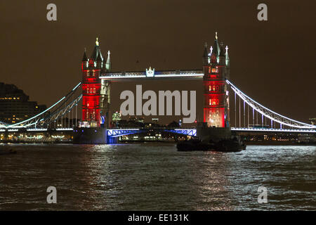 London, UK. 11th Jan 2015. Tower Bridge, seen here in red, is illuminated in the colours of the French Tricolore flag, as a tribute to the victims of the terrorist attacks in Paris. Credit:  Jamie Hunt/Alamy Live News Stock Photo