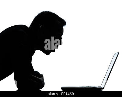 one caucasian business man computing computer laptop surprised portrait silhouette in studio isolated on white background Stock Photo