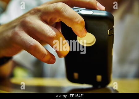 Man's hand holding black cell phone Stock Photo