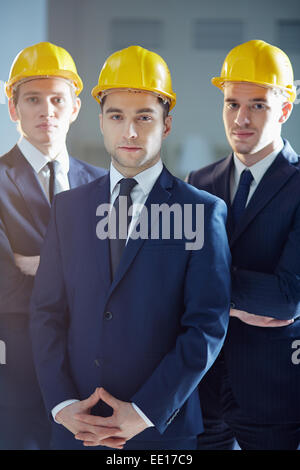 Portrait of three confident men in hardhats Stock Photo