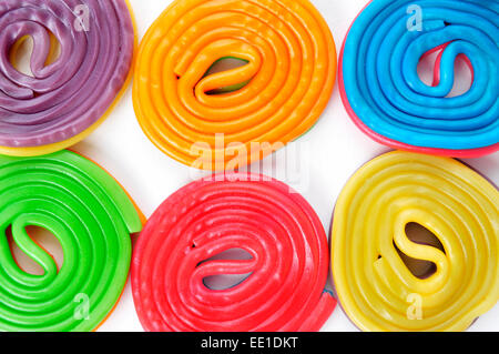 some licorice wheels of different colors on a white background Stock Photo