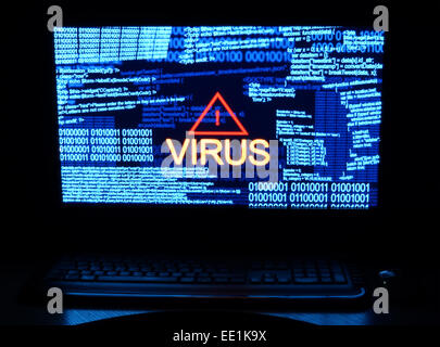 Computer in dark with word virus Stock Photo