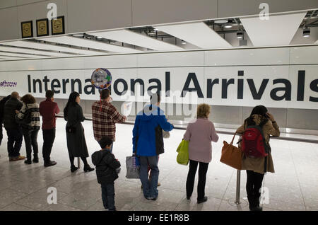 People waiting at International Arrivals at Heathrow airport in Britain Stock Photo