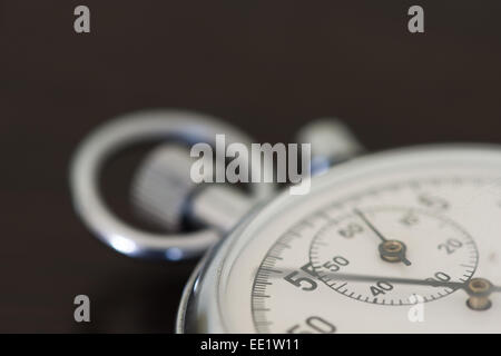 old silver chrome stopwatch with seconds and minute hands 5 second count down chronological timer glass dial buttons against Stock Photo