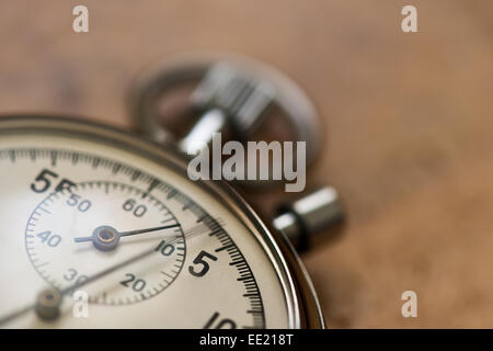 old silver chrome stopwatch with seconds and minute hands 5 second count down chronological timer glass dial buttons against Stock Photo