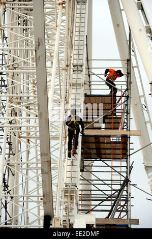 Brighton  UK 7th January 2015 - Workers carry out winter maintenance work on the Brighton Wheel of Excellence on the seafront Stock Photo