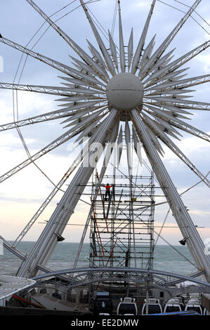 Brighton  UK 7th January 2015 - Workers carry out winter maintenance work on the Brighton Wheel of Excellence on the seafront Stock Photo