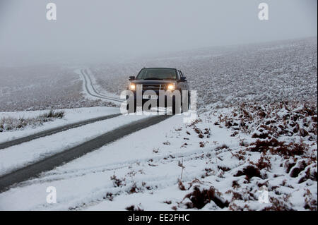 Mynydd Epynt Range of hills, Powys, Wales, UK. 13th January, 2015.  A four-wheel-drive vehicle negotiates a narrow road on the Epynt range of hills in Powys. Snow falls in Mid Wales as predicted by the weather forecasts. Credit:  Graham M. Lawrence/Alamy Live News. Stock Photo