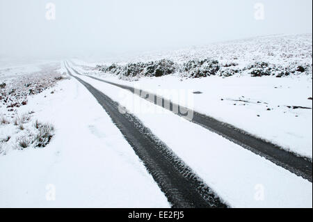 Mynydd Epynt Range of hills, Powys, Wales, UK. 13th January, 2015. A narrow road is on the Epynt range of hills in Powys. Snow falls in Mid Wales as predicted by the weather forecasts. Credit:  Graham M. Lawrence/Alamy Live News. Stock Photo