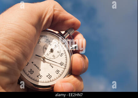 old silver chrome stopwatch with seconds and minute hands 5 second count down chronological timer glass dial buttons against Stock Photo