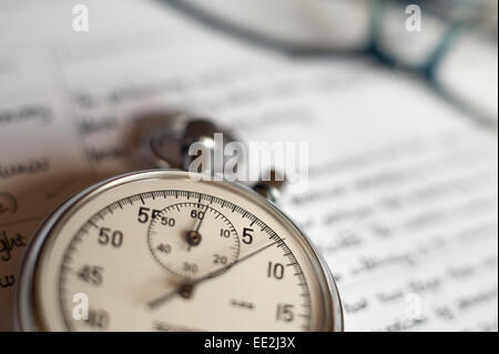 old silver chrome stopwatch with seconds and minute hands 5 second count down chronological timer glass dial buttons against Stock Photo