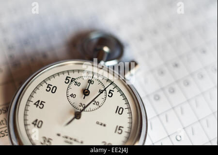 old silver chrome stopwatch with seconds and minute hands 5 second count down chronological timer glass dial buttons against Stock Photo