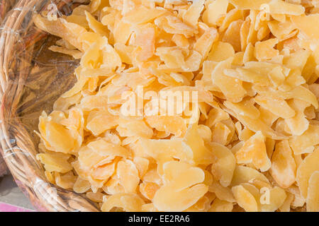 Candied and dried Crystallized Ginger slices in wicker bowl Stock Photo