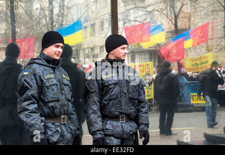Kiev, Ukraine. 13th Jan, 2015. Two police officers watching the action on the background of glass, which reflects the protesters. -- Zhytomyr confectionary factory workers need to dismiss the Prosecutor General of Ukraine Vitaly Yarema and his first deputy Oleg Bachun. Kiev, January 13, 2015, the factory's picketed the Attorney General for the ninth time. Traditionally, the protesters brought garbage cans, banners and drums in metal drums. Credit:  Igor Golovnov/Alamy Live News Stock Photo