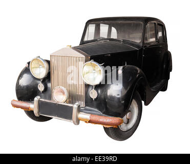 Old, classic car with rusty bumper and fading black paint, isolated against a plain, white background. Stock Photo