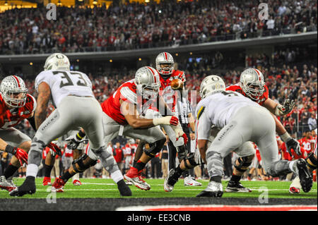 Ohio State quarterback Cardale Jones (12) takes the snap from center during the College Football Playoff National Championship at AT&T Stadium Monday, Jan. 12, 2015, in Arlington, Texas. Stock Photo