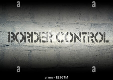 border control stencil print on the grunge white brick wall Stock Photo