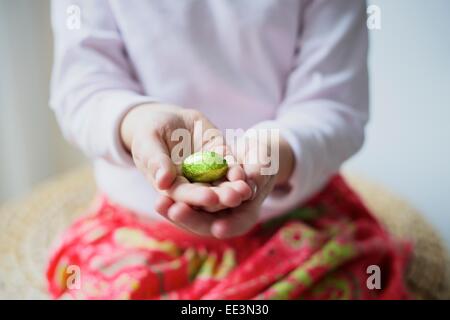 Liitle girl gathering Easter eggs, close-up Stock Photo