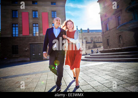 Senior couple walking over city square, Munich, Bavaria, Germany Stock Photo