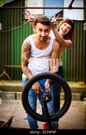 Young couple in workshop fooling around Stock Photo