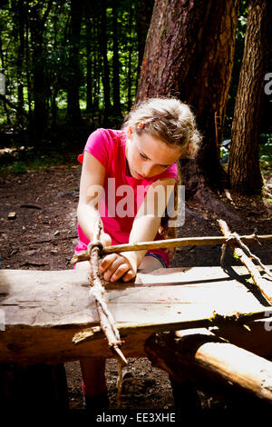 Girl crafting in a forest camp, Munich, Bavaria, Germany Stock Photo