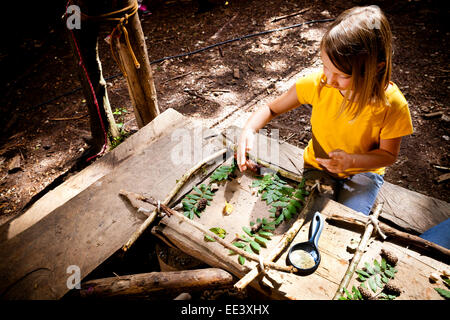 Girl crafting in a forest camp, Munich, Bavaria, Germany Stock Photo