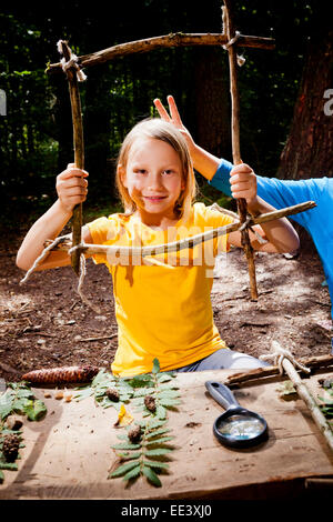 Children crafting in a forest camp, Munich, Bavaria, Germany Stock Photo