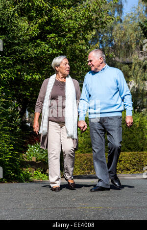 Elderly couple, both in their mid 70 taking a walk, Stock Photo