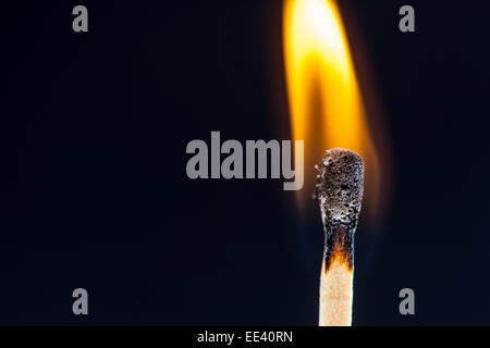Match, just ignited flame at the match head, Stock Photo