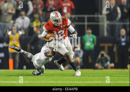 Ohio State quarterback Cardale Jones (12) is tackled by Oregon defensive back Reggie Daniels (8) during the College Football Playoff National Championship at AT&T Stadium Monday, Jan. 12, 2015, in Arlington, Texas. Stock Photo