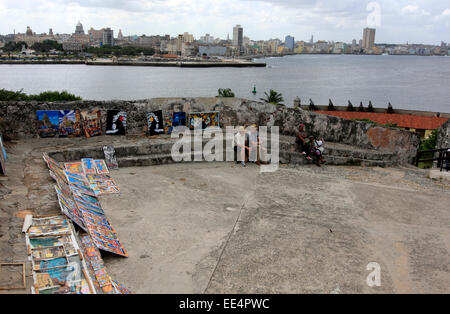 Selling pictures inside the old walls of the Morro Castle in Havana, Cuba with the Havana skyline in the background Stock Photo