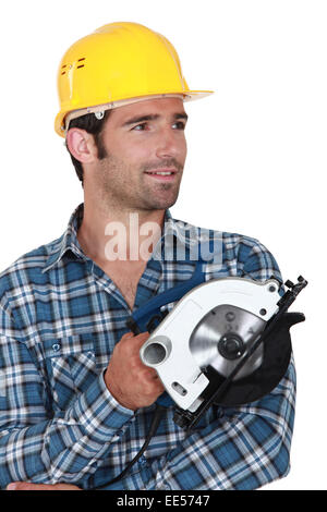 Carpenter stood holding circular saw Stock Photo