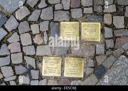 Memorial plaques (Stolpersteine) set into the pavement in Berlin to commemorate the deportation and murder of a Jew residant at Stock Photo