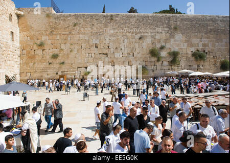 JERUSALEM, ISRAEL - OCT 06, 2014: A lot of religious jewish people in front of the western wall in the old city of Jerusalem Stock Photo