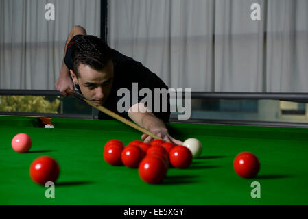 Young man playing snooker Stock Photo