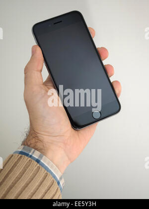 Man hand holding Apple iPhone with Wikipedia start page on a screen ...