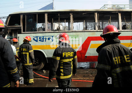 Dhaka, Bangladesh. 14th Jan, 2015. Firefighters try to extinguish fire of a burning bus during the nonstop blockade called by Bangladesh Nationalist Party (BNP) in Dhaka, Bangladesh, Jan. 14, 2015. With the death of four more people Wednesday, the number of deaths reached 17 on the ninth day of the opposition-led indefinite blockade in Bangladesh. Credit:  Shariful Islam/Xinhua/Alamy Live News Stock Photo