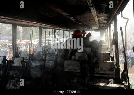 Dhaka, Bangladesh. 14th Jan, 2015. Firefighters try to extinguish fire of a burning bus during the nonstop blockade called by Bangladesh Nationalist Party (BNP) in Dhaka, Bangladesh, Jan. 14, 2015. With the death of four more people Wednesday, the number of deaths reached 17 on the ninth day of the opposition-led indefinite blockade in Bangladesh. Credit:  Shariful Islam/Xinhua/Alamy Live News Stock Photo