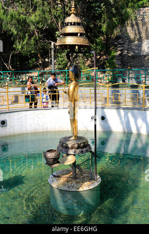 Golden statue of Buddha in the World Peace Pond, Monkey Temple, UNESCO World Heritage Site, Swayambhunath, Kathmandu city, Nepal Stock Photo