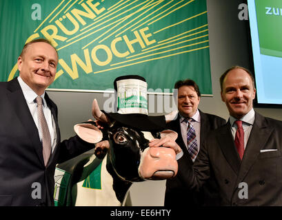 Joachim Rukwied (L-R), President of the German Farmers' Association, Christoph Minhoff, manager of the umbrella association of the food industry, and Christian Goeke, manager of Messe Berlin, stand around the plastic cow of the 'Erlebnisbauernhof' before the beginning of the opening press conference of the 80th Green Week in Berlin, Germany, 14 January 2015. More than 1,600 exhibitors present their products in 26 hall complexes under the Funkturm Berlin from 16 until 25 January 2015. Latvia is this year's partner country. PHOTO: BERND SETTNIK/dpa Stock Photo