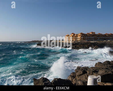 Waves crashing onto rocky sea front Caleta de Fuste Fuerteventura Canary Islands viewed from a path around the coastline on this popular winter venue Stock Photo