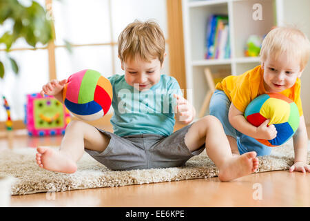 kids boys play with ball indoor Stock Photo
