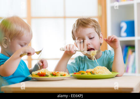 kids eating healthy food in kindergarten or nursery Stock Photo