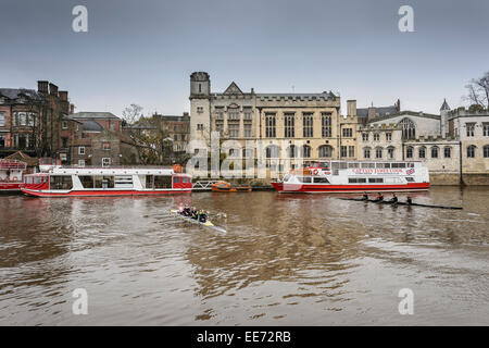 Two rowing crews turn around in front of York Guildhall on the River Ouse in the centre of York Stock Photo