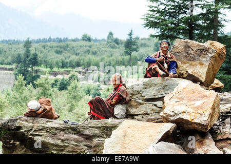 India, Himachal Pradesh, Manali - local herders resting on a big rocks Stock Photo