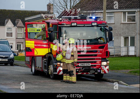 Haverfordwest, UK Wednesday 14 January 2015  Firemen attend to help make some of the roofs safe    Two people were taken to hospital after a mini-tornado struck a row of houses in Haverfordwest, Pembrokeshire Stock Photo