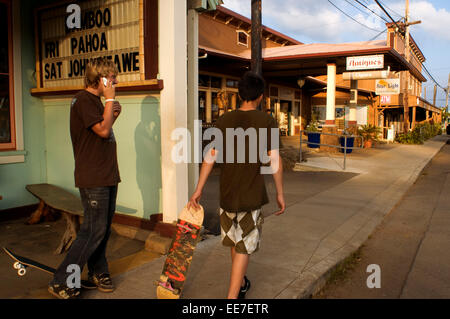 Skaters in Hawi. Hawi is the most northern town. Wooden houses painted in bold colors transform you into an atmosphere of the se Stock Photo